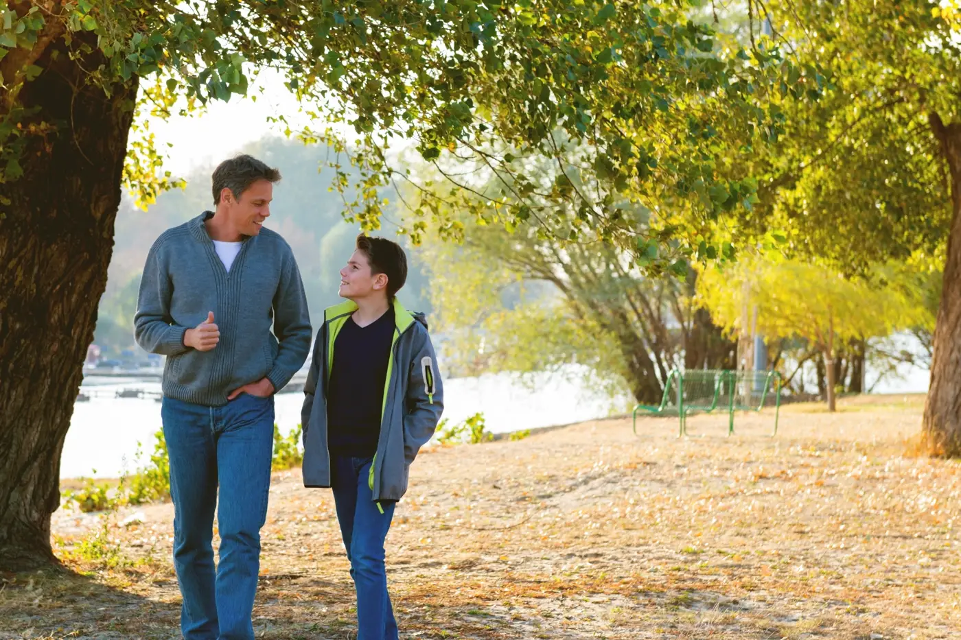 Parent and child discussing how to choose the right Swiss boarding school in a calm outdoor environment