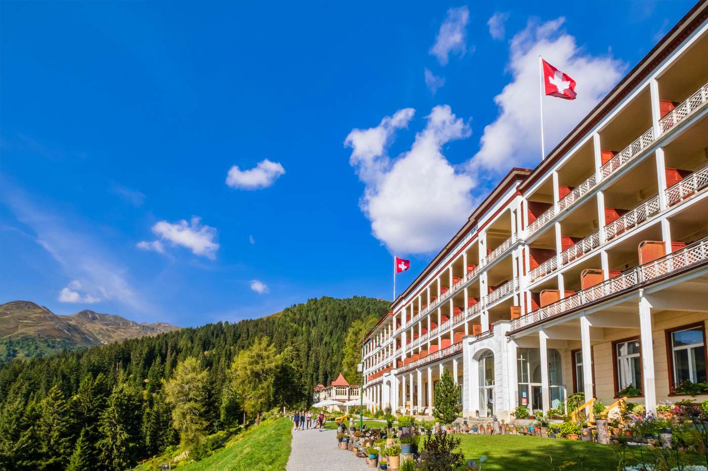 Swiss boarding school campus in the Swiss Alps with students and Swiss flag