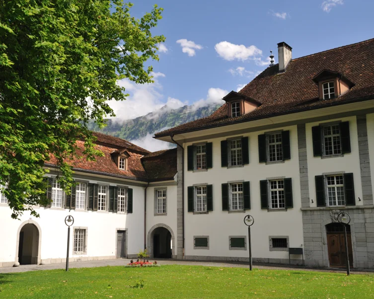 Swiss boarding school campus overlooking lake and mountains in Switzerland