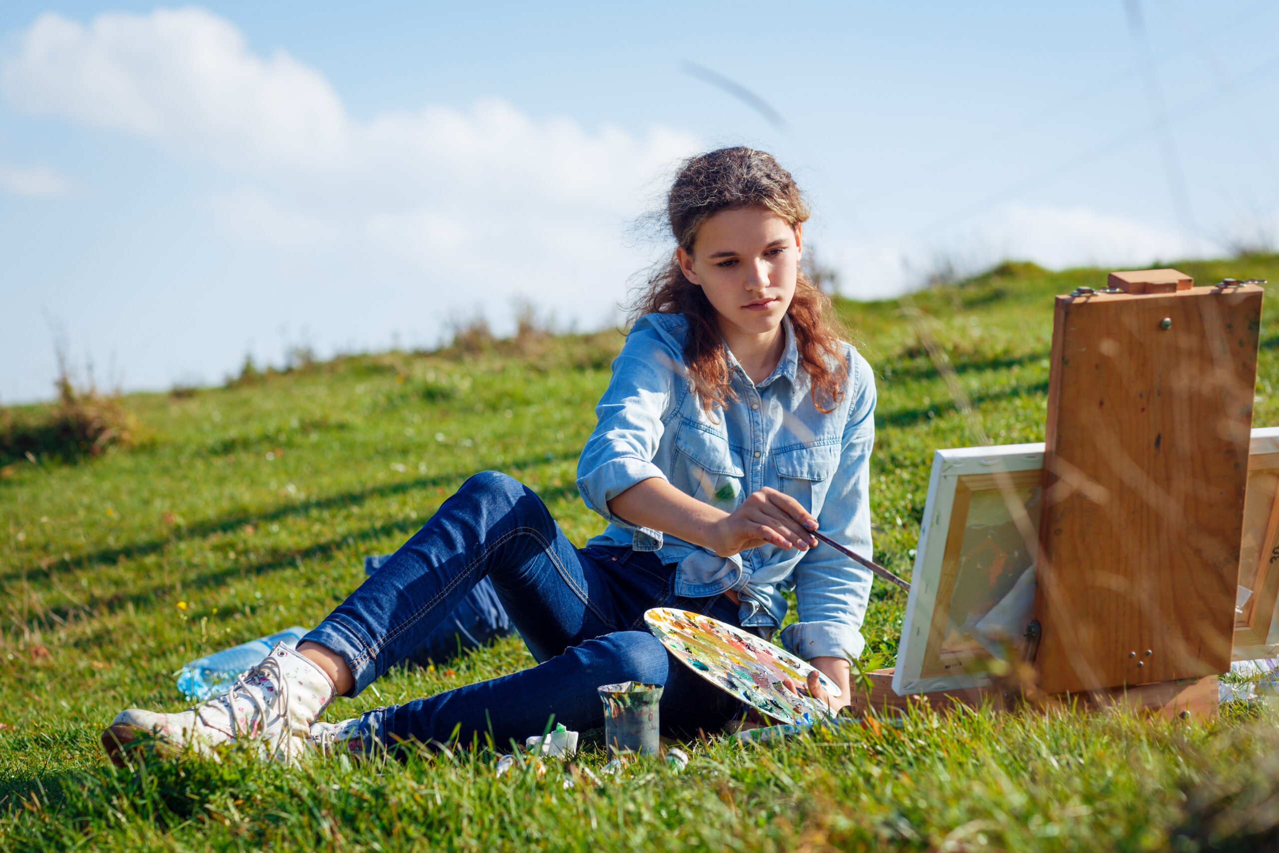 Student participating in creative activities during a Swiss summer camp in a natural outdoor environment
